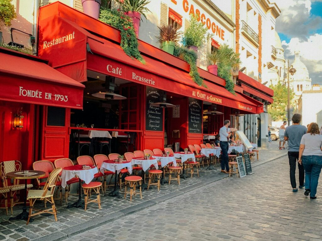people sitting on chair near red building during daytime