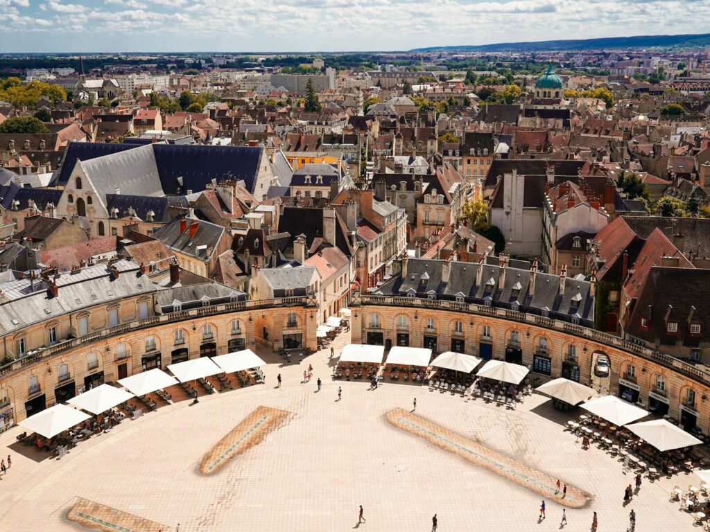 Aerial view of a historic european town square with arcades.